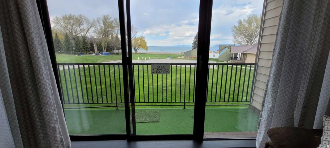 Sliding glass door leading to an outdoor balcony with black metal railings