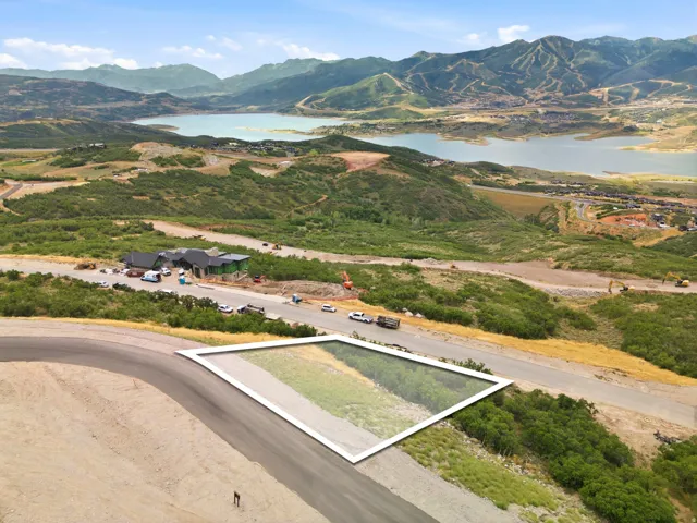 Roadside property with a mountain and lake backdrop