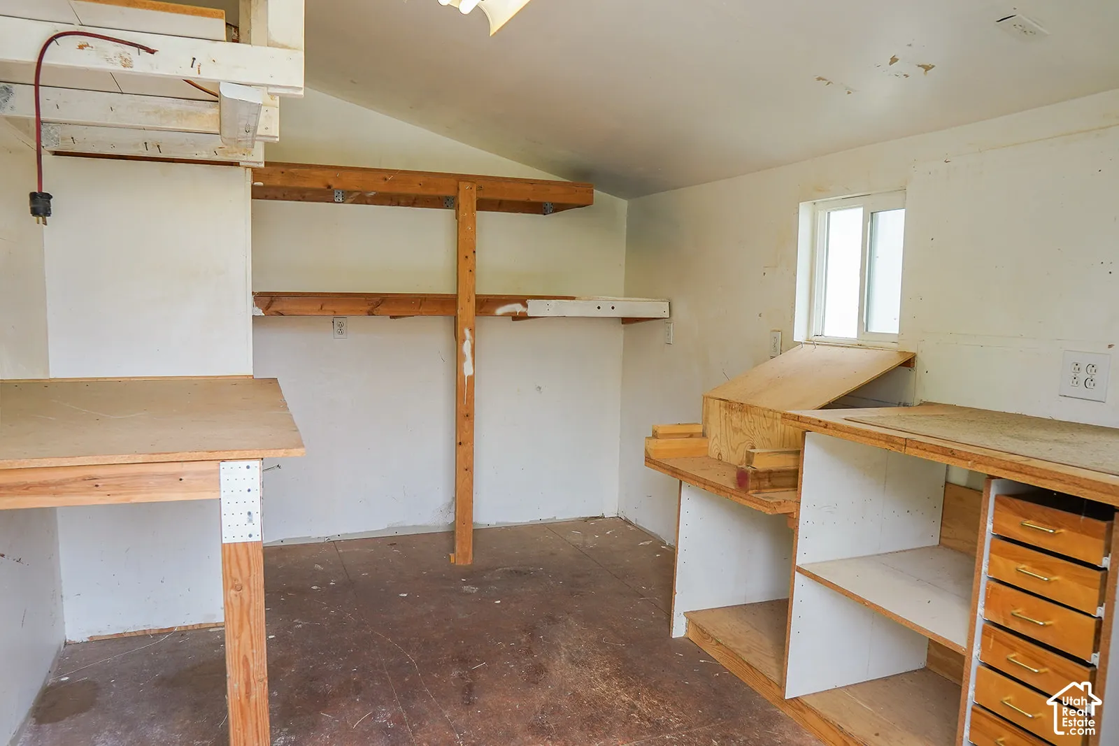 Built-in shelving, multiple work surfaces, and integrated drawer storage