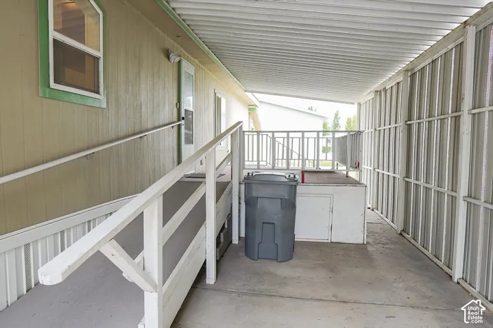 Covered concrete slab with an attached ramp and white railing