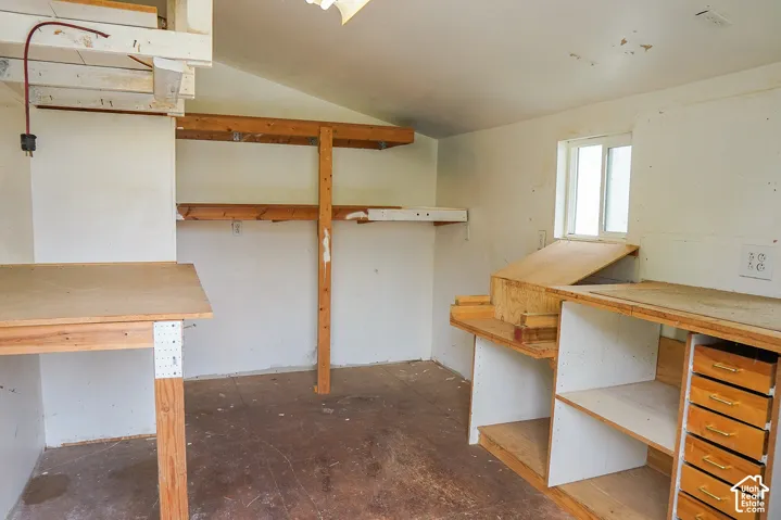Built-in shelving, multiple work surfaces, and integrated drawer storage