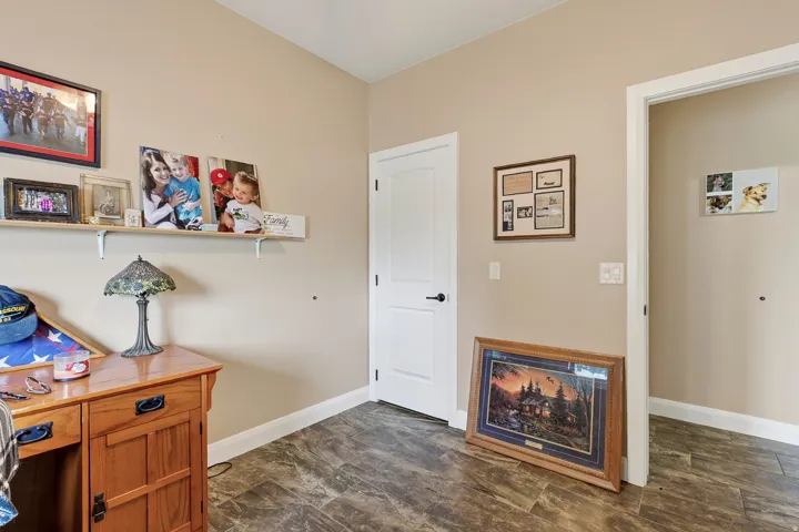 Welcoming foyer showcasing wood-finish flooring, warm neutral walls, and multiple doorway entries