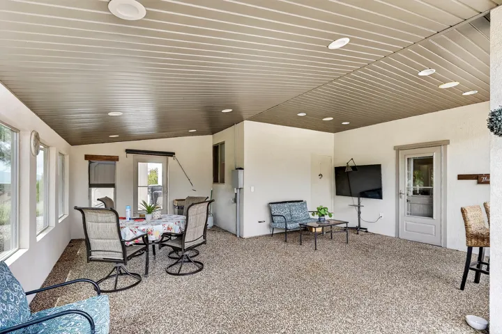 Spacious open-concept living area featuring recessed ceiling lighting, neutral wall finishes, and expansive carpeting