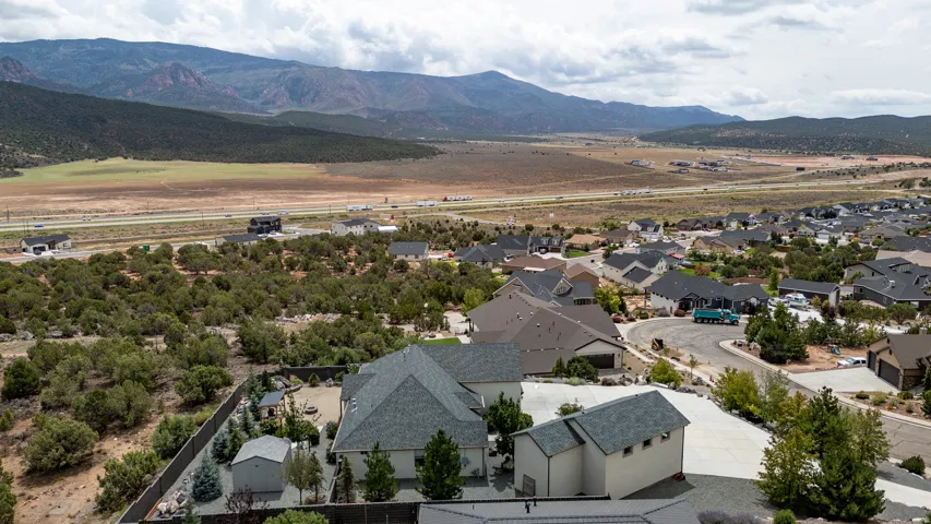 Residential neighborhood with mountainous backdrop, highways, and surrounding natural landscape