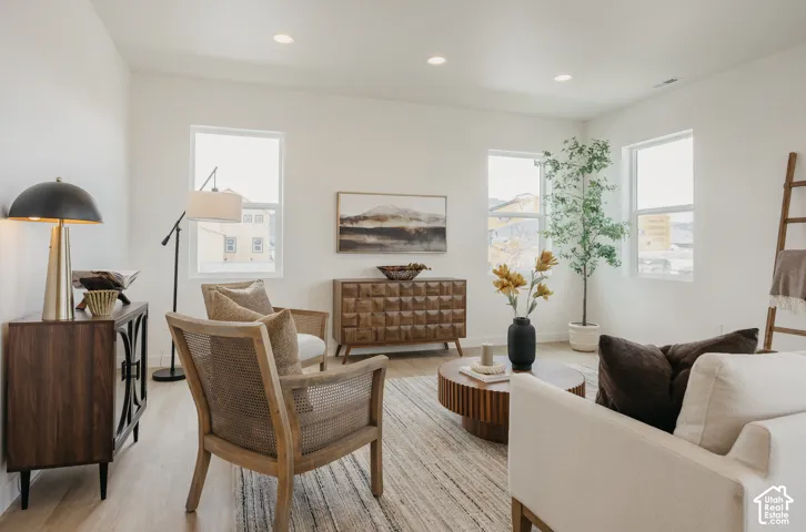 Recessed lighting, light wood-finish flooring, and multiple large windows