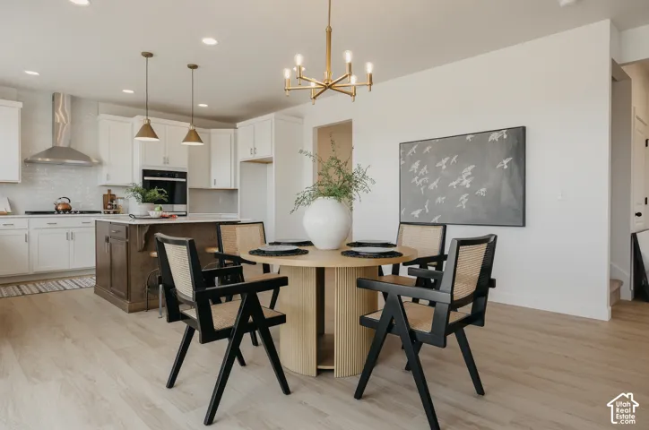 Light wood-finish flooring with a modern gold chandelier