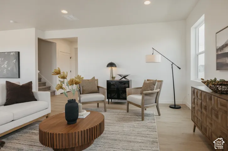 Recessed lighting, wood-finish flooring, and white walls