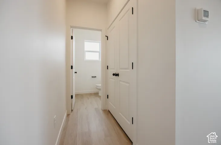 Light wood-finish flooring with white walls and trim throughout