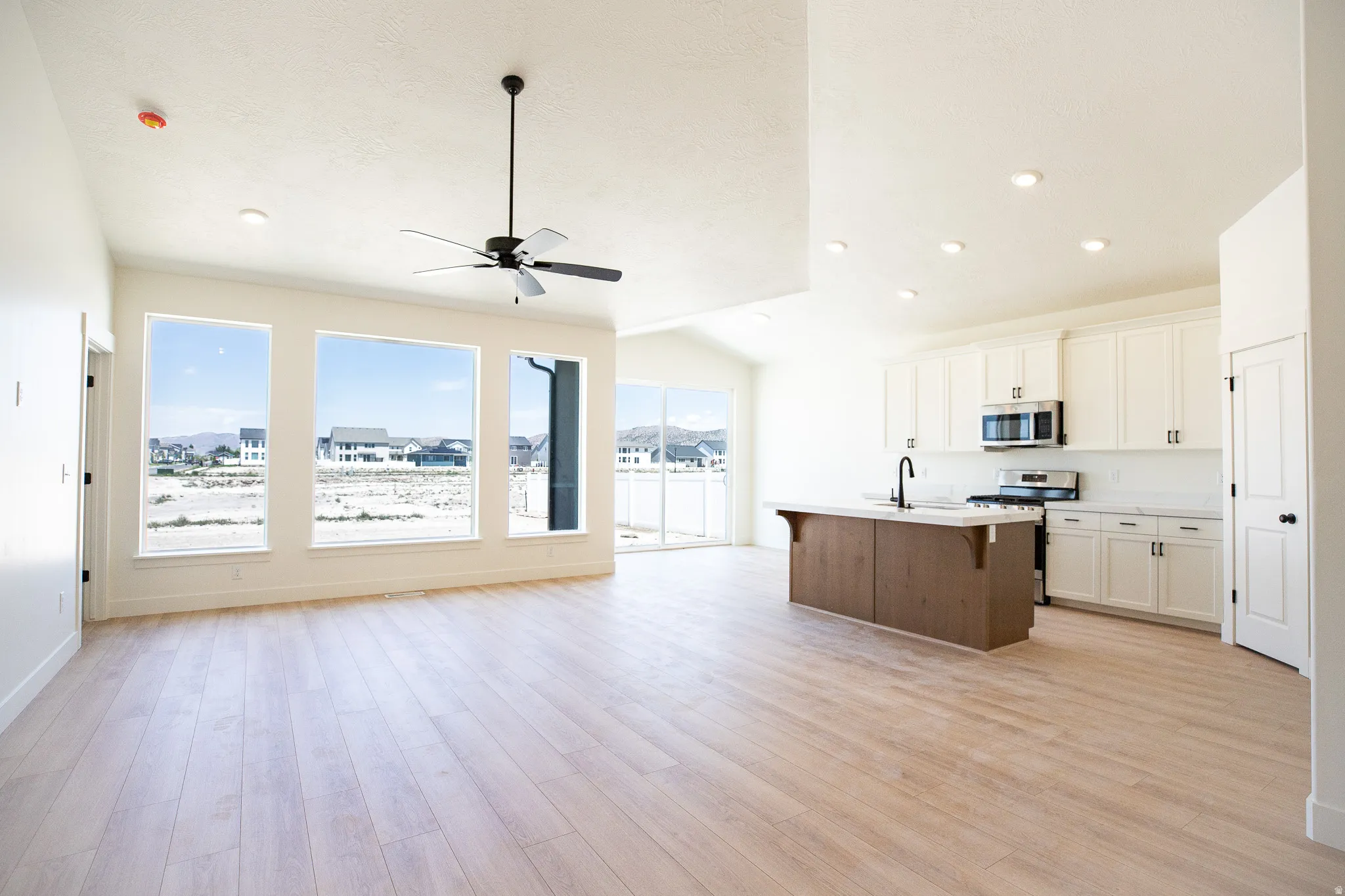 Open dining area adjacent to kitchen and family/great room with picture windows and 8' sliding glass door.