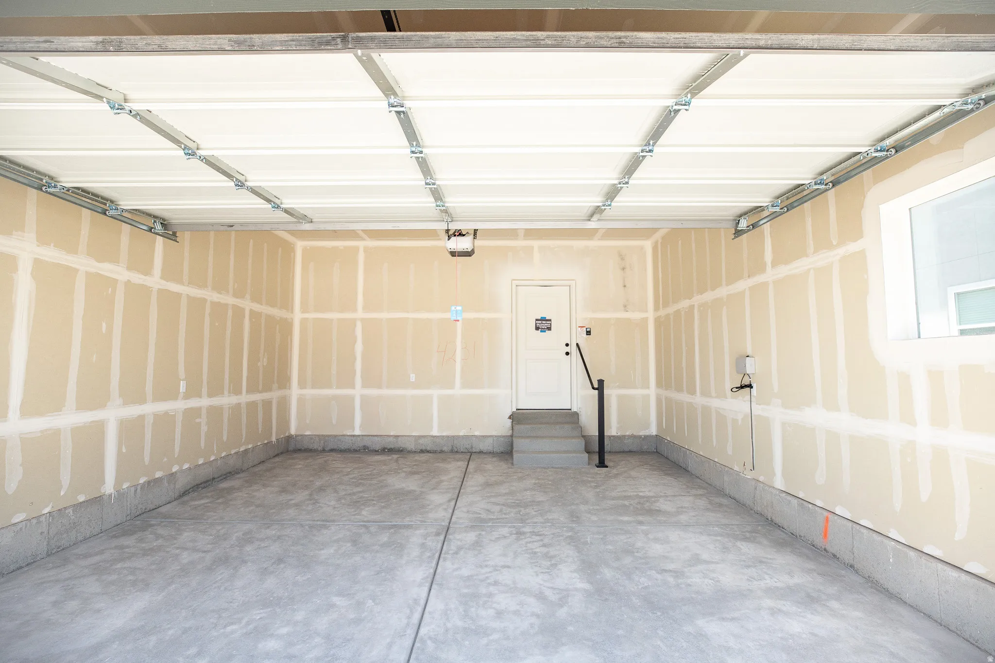 2-car garage with taped drywall.