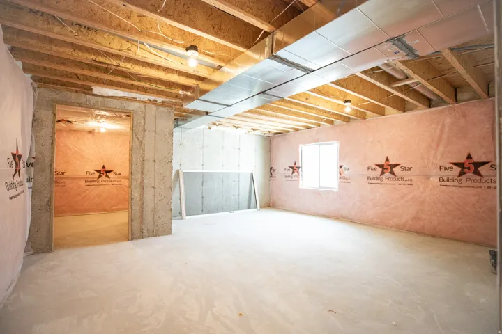 Unfinished basement with potential for third bedroom and full bathroom.