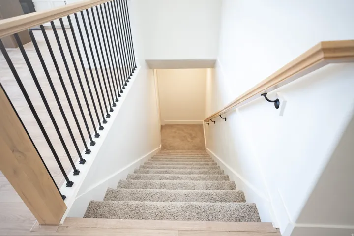 Fully finished stairs to unfinished basement.