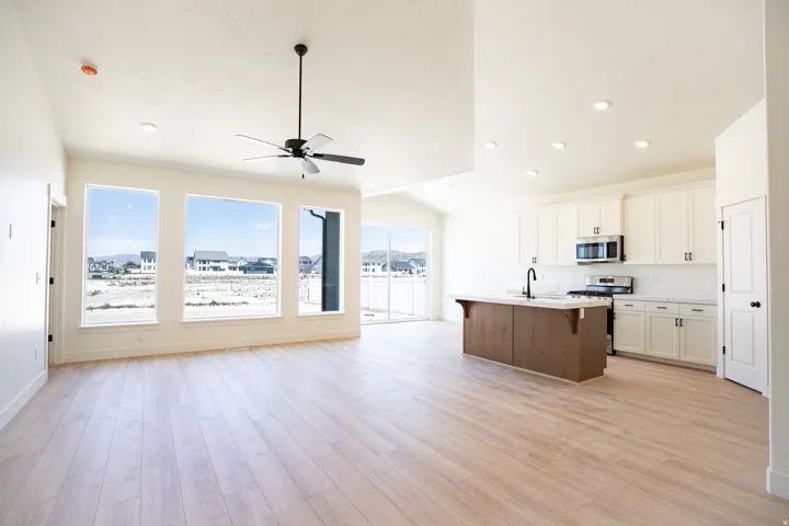 Open dining area adjacent to kitchen and family/great room with picture windows and 8' sliding glass door.