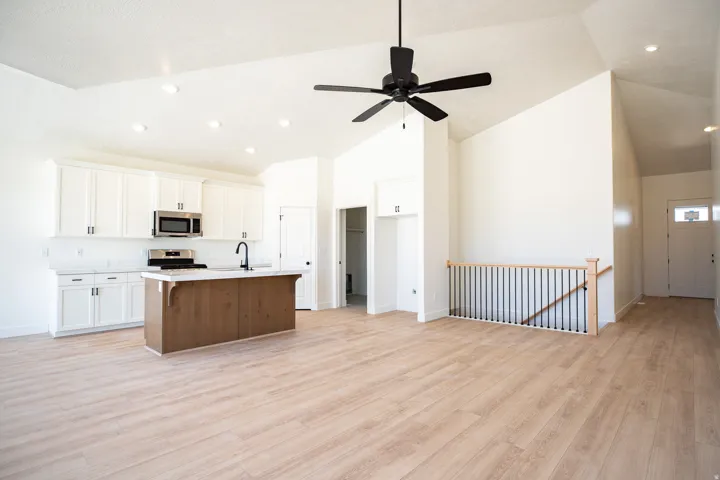 Family/Great room with vaulted ceiling and ceiling fan.