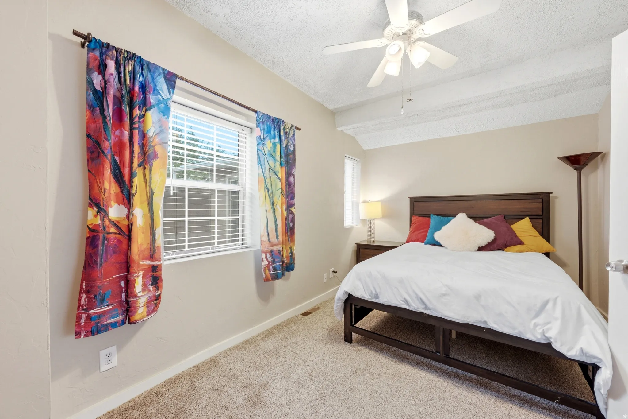 Carpeted flooring, window with horizontal blinds, textured ceiling, ceiling fan with light fixture, and neutral wall paint