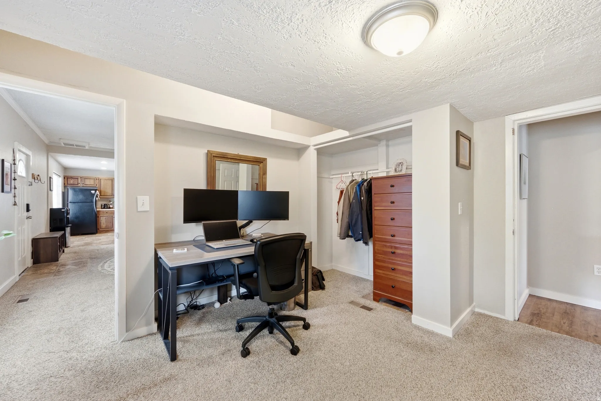 Carpeted flooring, recessed wall niche, and an integrated closet system