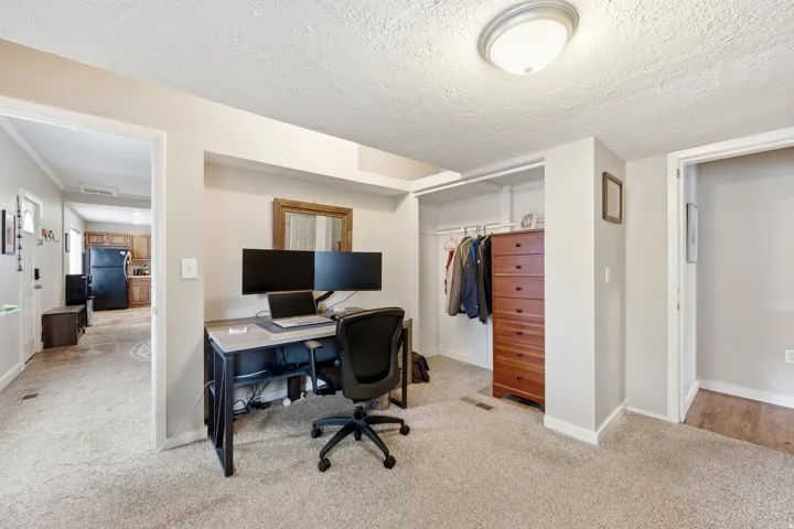Carpeted flooring, recessed wall niche, and an integrated closet system