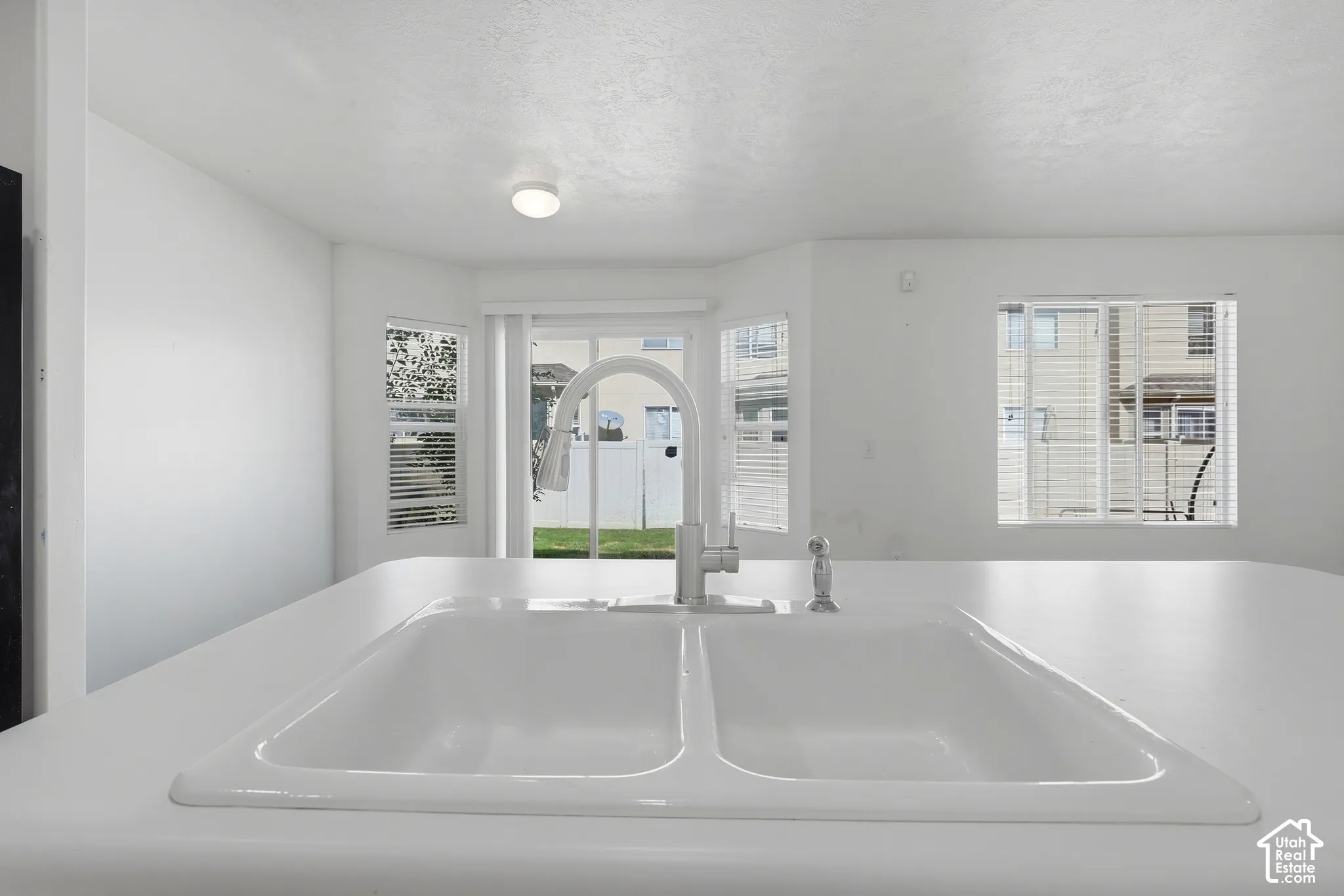 Integrated dual-basin sink with a gooseneck faucet