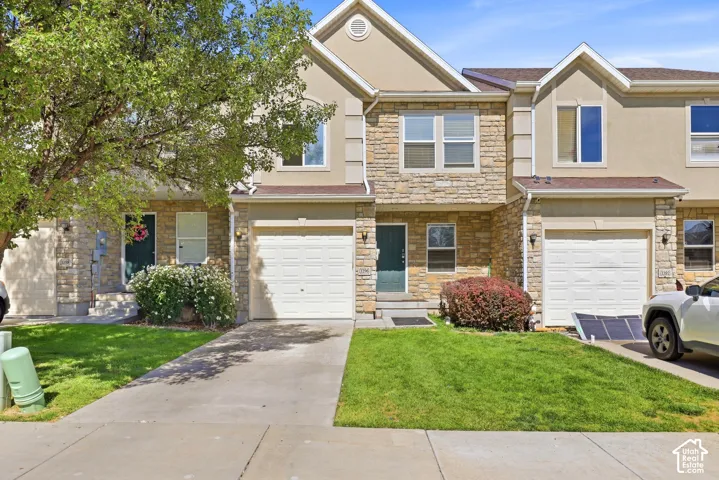 Stone veneer and stucco exterior with multiple windows