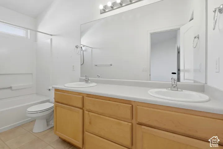 Dual vanity with light wood-finish cabinetry and integrated sinks
