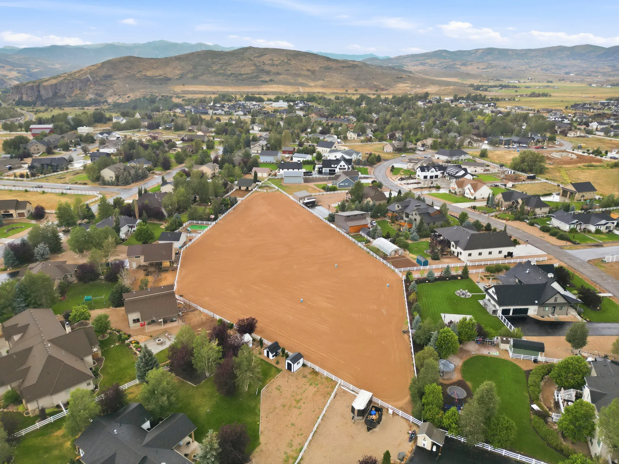 Expansive land parcel featuring a perimeter fence and a large, cleared flat area