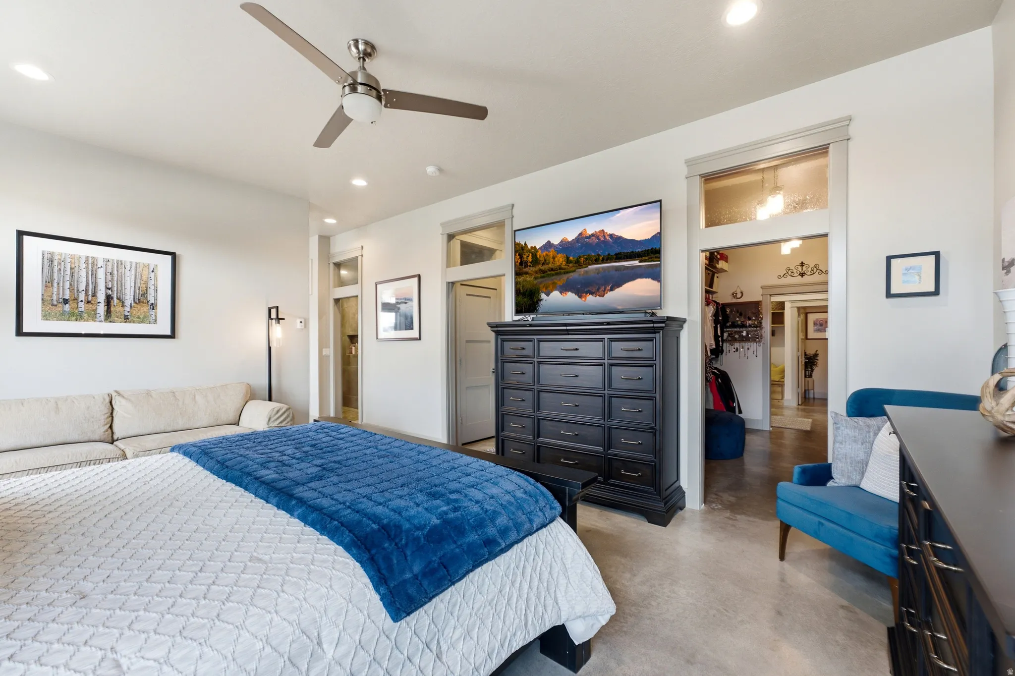 Recessed lighting, ceiling fan, concrete flooring, and multiple doorways