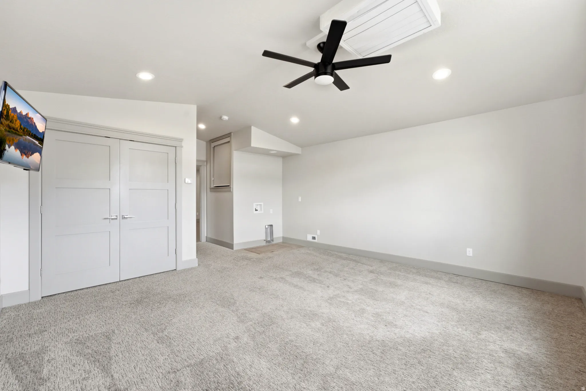 Vaulted ceiling with recessed lighting and a ceiling fan, carpeted flooring, and light-toned walls