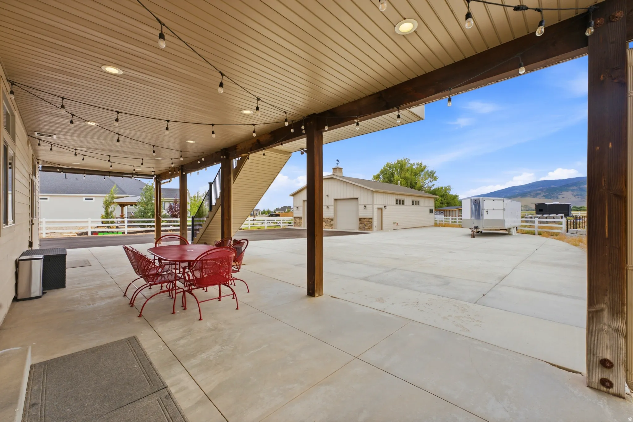 Expansive covered patio with recessed lighting and string lights