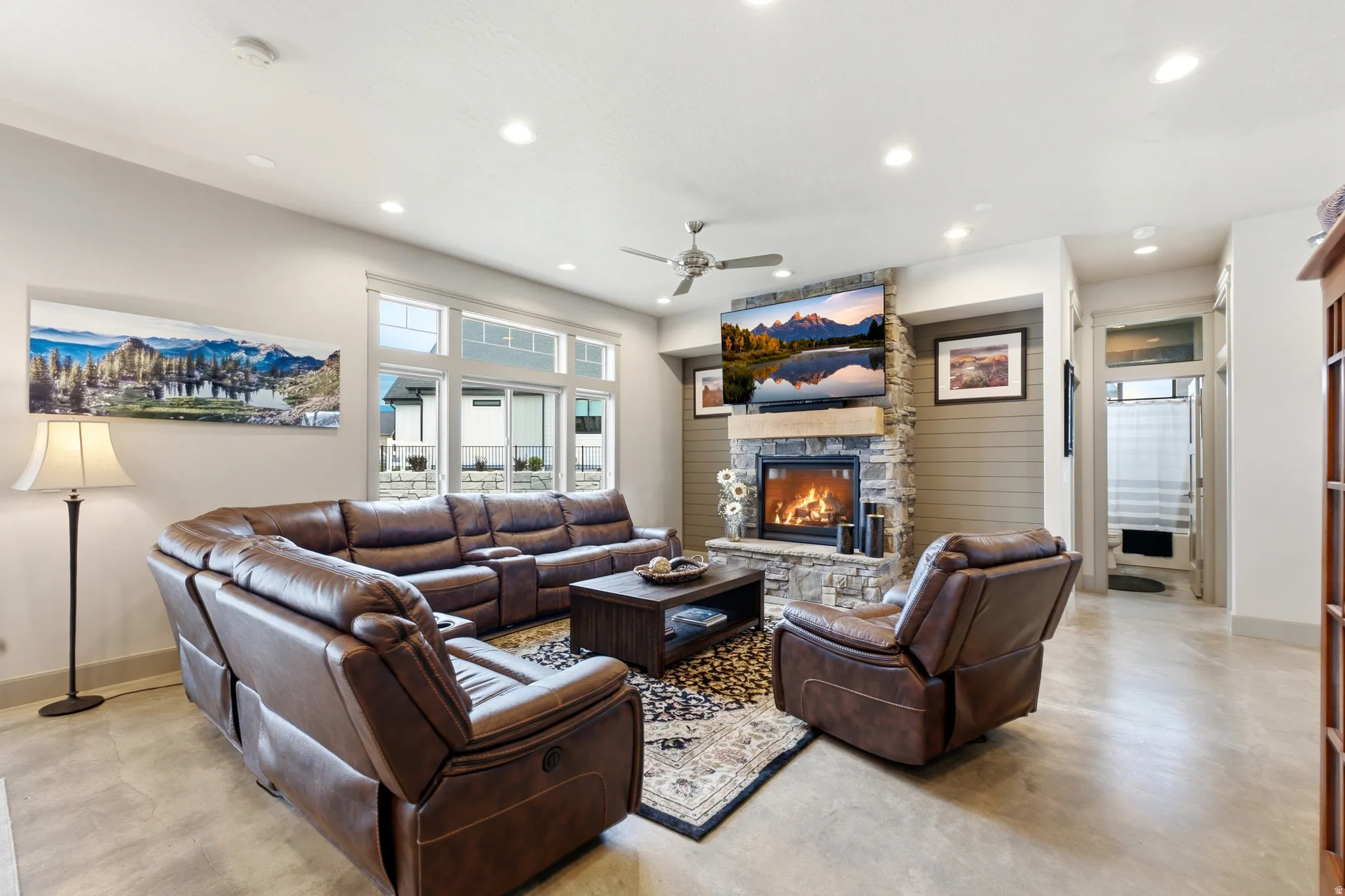 Recessed lighting, ceiling fan, and large windows provide illumination