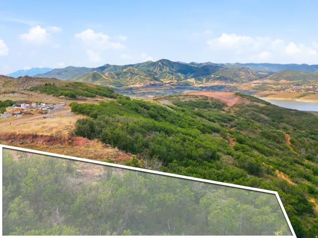 Mountainous terrain with lush green foliage, expansive sky, and distant body of water