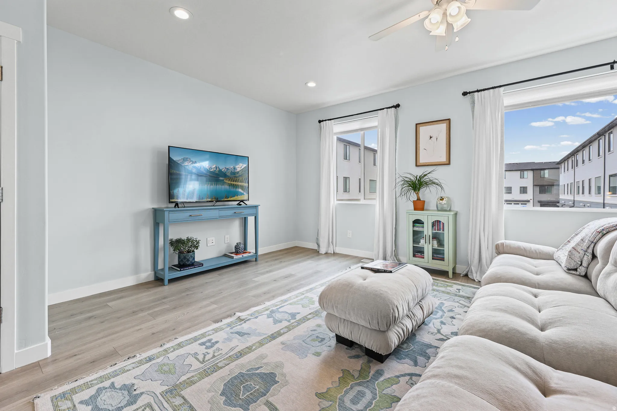 Recessed lighting, wood-finish flooring, and white trim