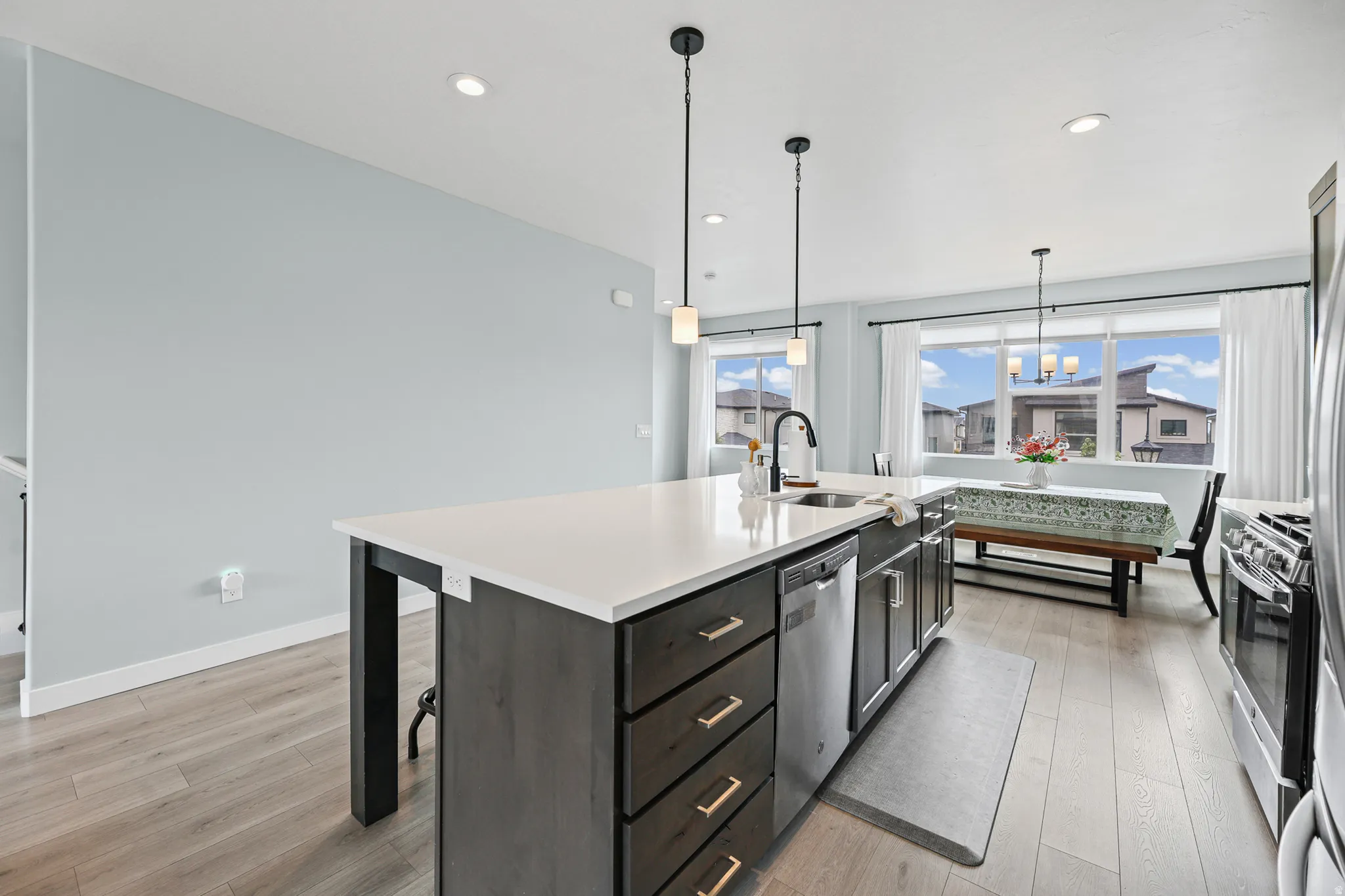 Kitchen island with a white countertop and dark wood-finish cabinetry