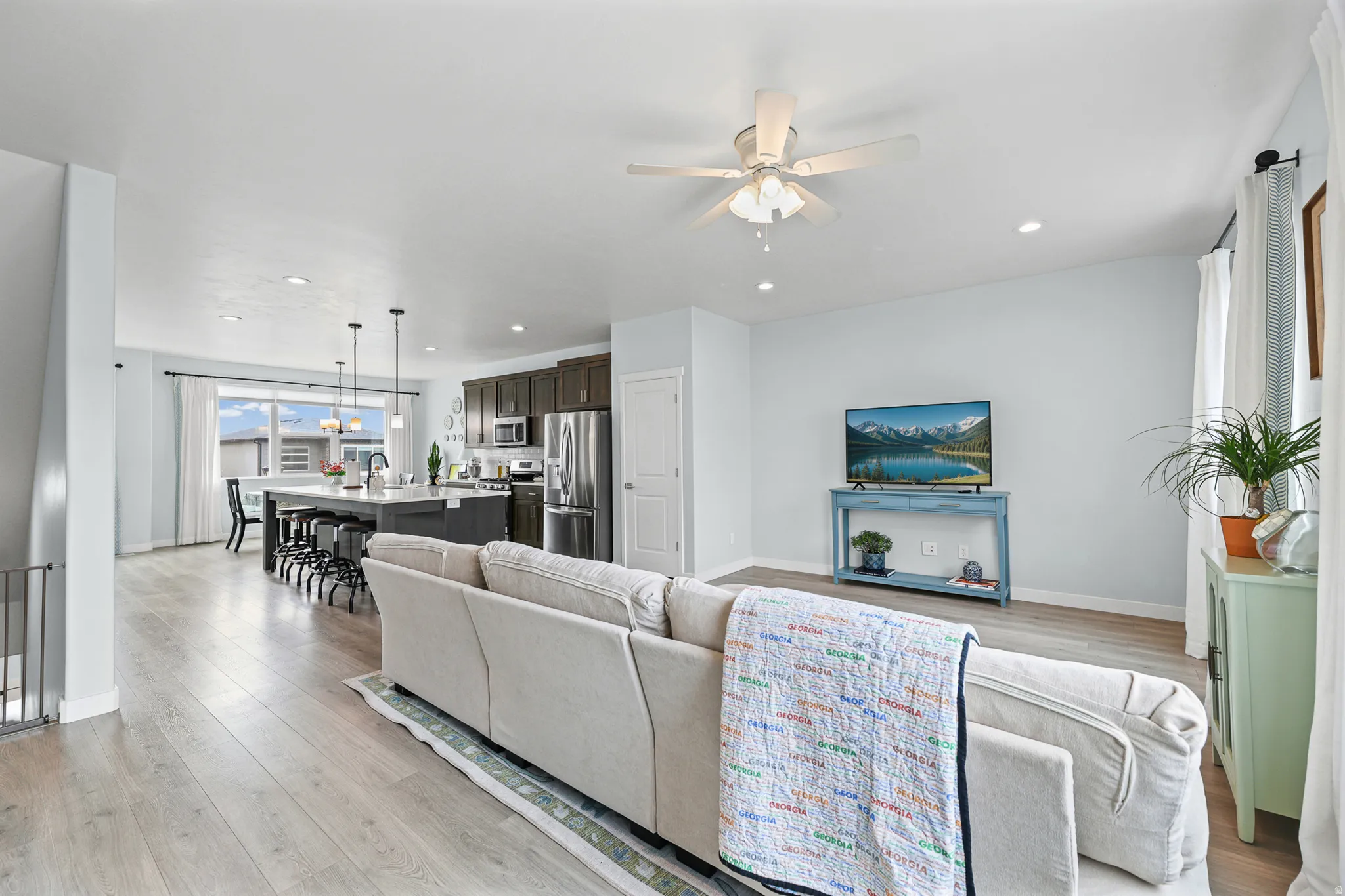Open concept living area with wood-finish flooring