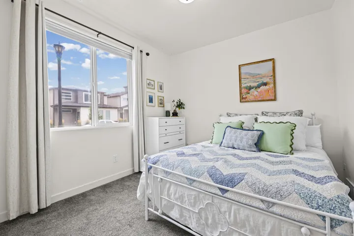 White walls complement the gray carpeting