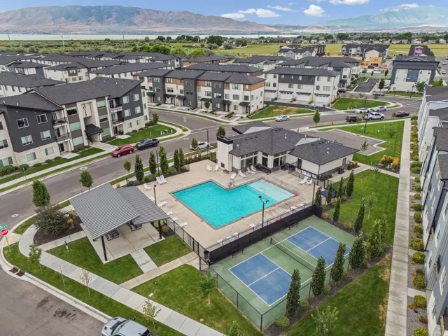 Community amenities featuring a swimming pool, covered outdoor dining area, and two sports courts