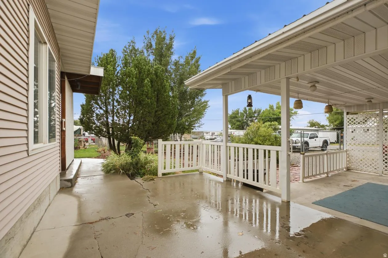 Covered patio with white railing and lattice screen