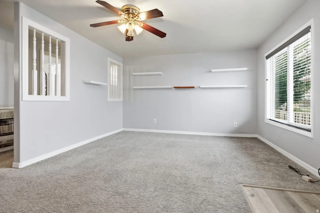 Recessed lighting with a ceiling fan, light gray wall paint, built-in shelving, white trim, and a window with blinds