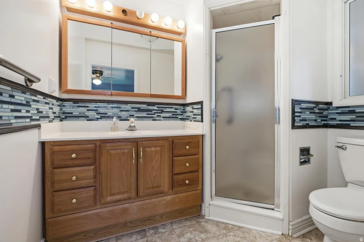 Wood-finish vanity with a white countertop and rectangular sink