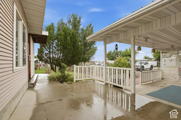 Covered patio with white railing and lattice screen