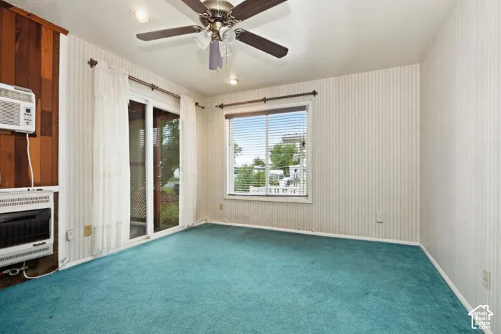 Spacious interior with a ceiling fan, recessed lighting, and a window with blinds