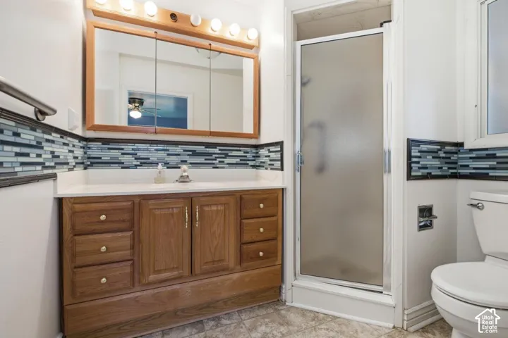 Wood-finish vanity with a white countertop and rectangular sink