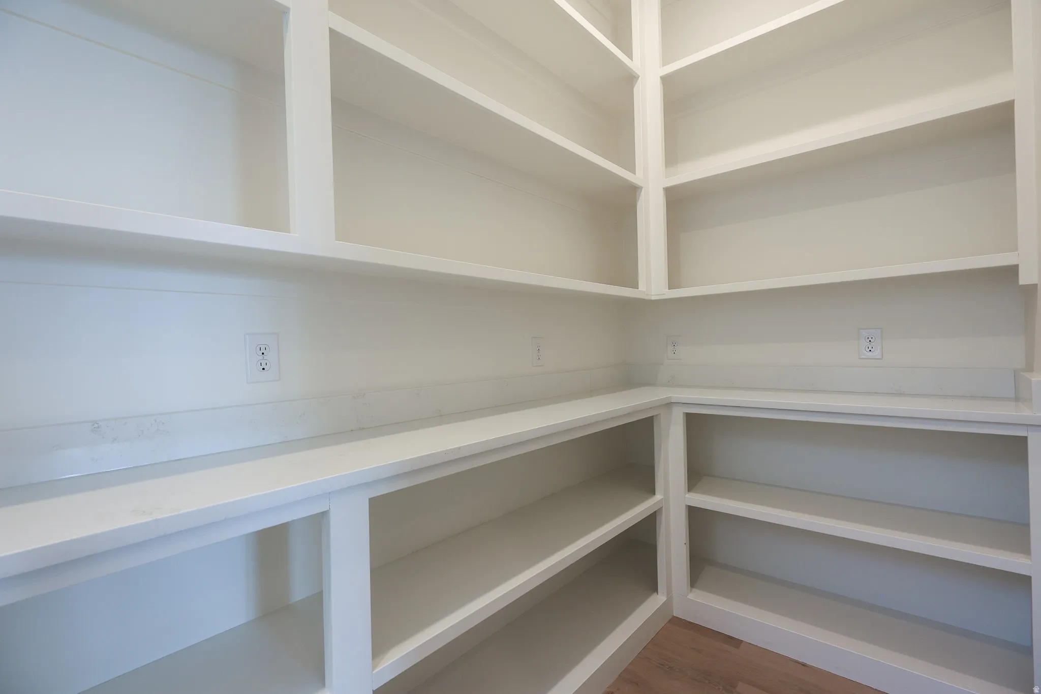 Built-in shelving, extensive countertop space, wood-finish flooring, and multiple electrical outlets