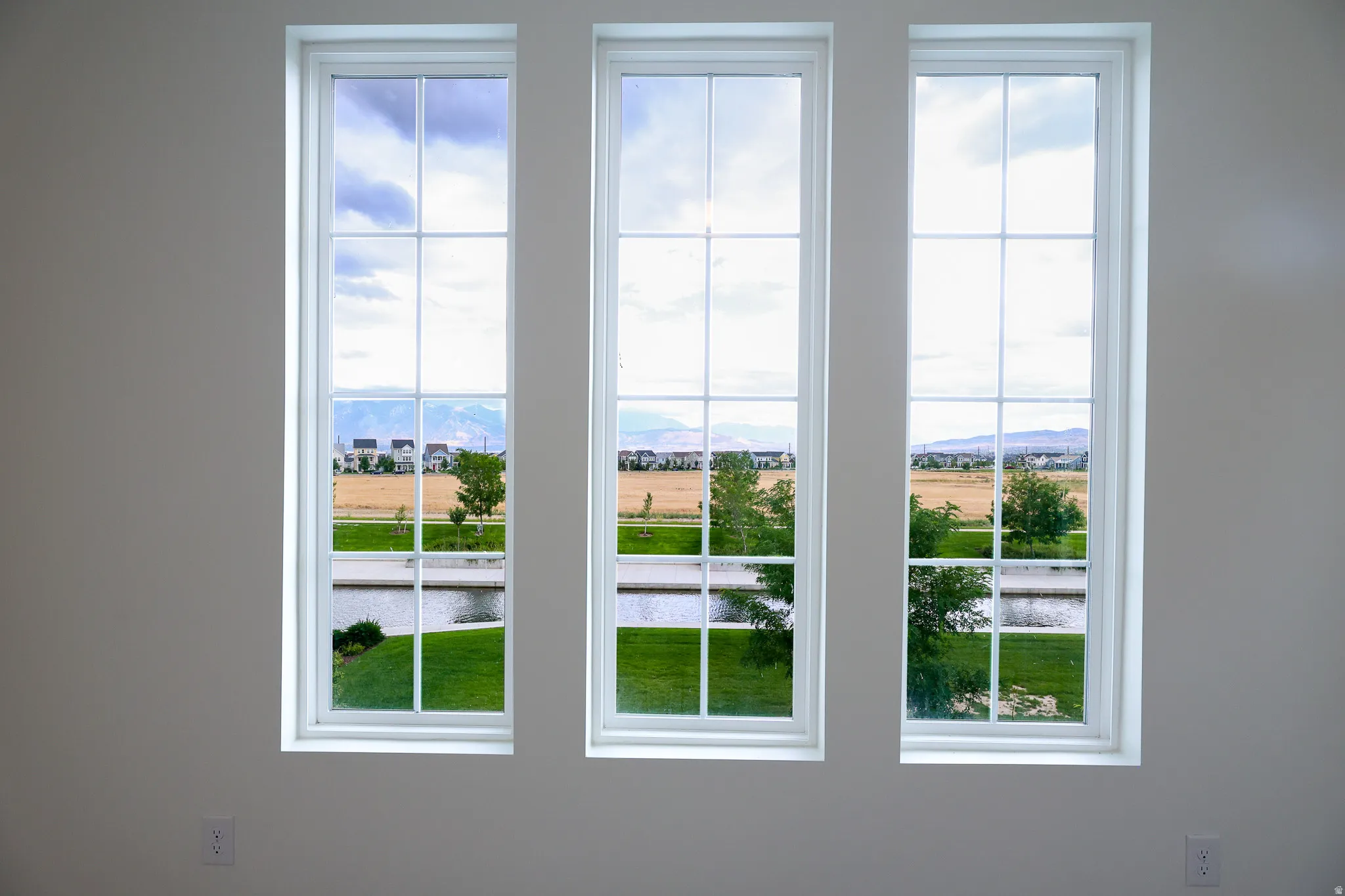 Three large windows overlooking watercourse