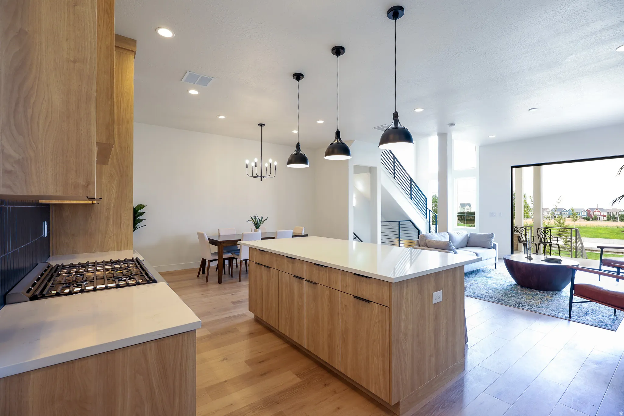 Open-concept layout featuring wood-finish flooring and recessed lighting