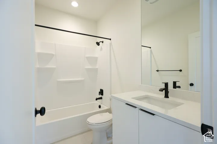 ADU-White vanity with integrated sink, sleek black hardware, and a framed mirror
