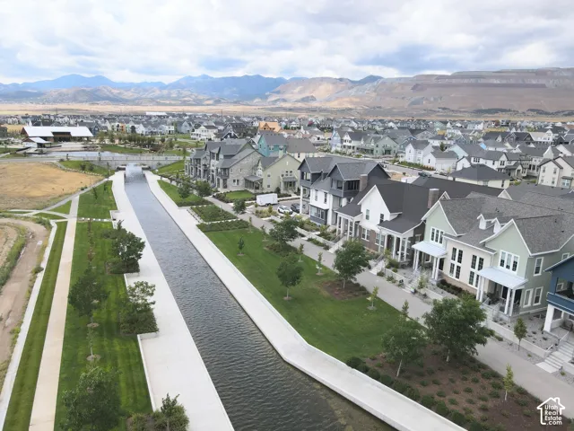 Luxury residential community featuring elegant architectural design with multi-story homes, manicured landscaping, and a scenic waterfront canal system
