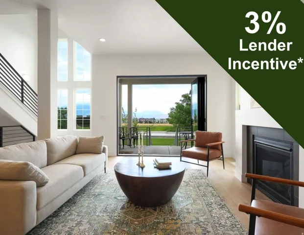 Vaulted ceiling with multiple windows, wood-finish flooring, a contemporary fireplace, and a large sliding glass door opening to an outdoor patio