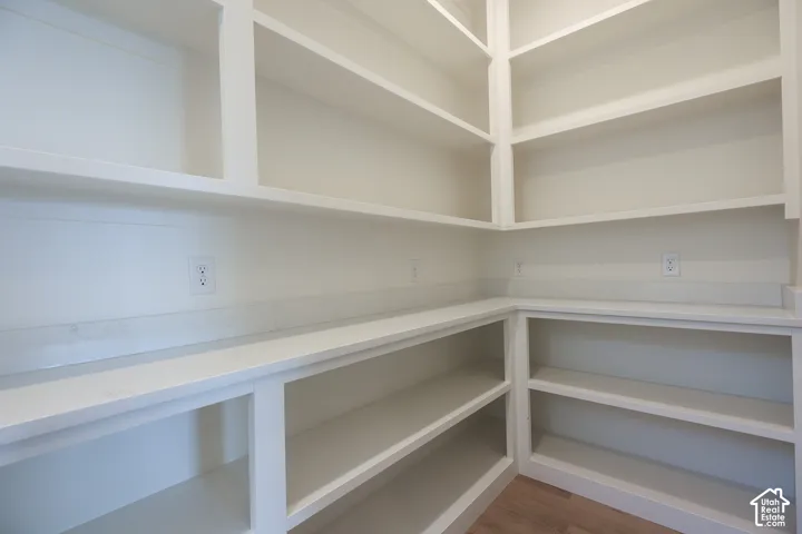 Built-in shelving, extensive countertop space, wood-finish flooring, and multiple electrical outlets