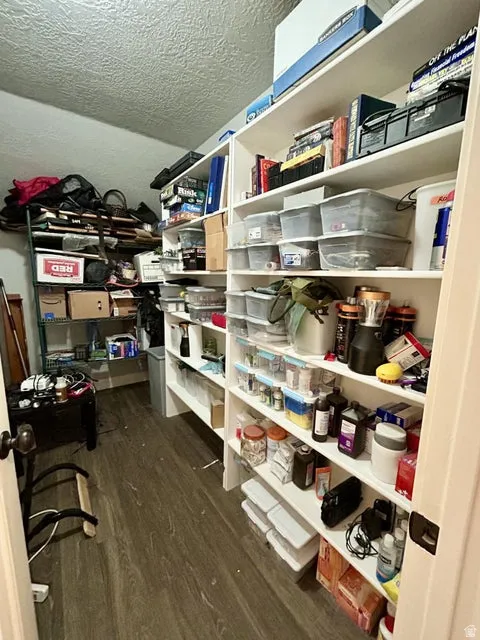 Built-in shelving, wood-finish flooring, and white painted walls