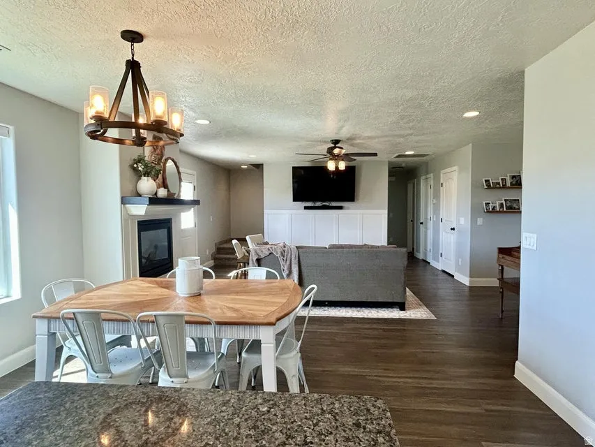 Open concept living space featuring a fireplace, wood-finish flooring, and recessed lighting